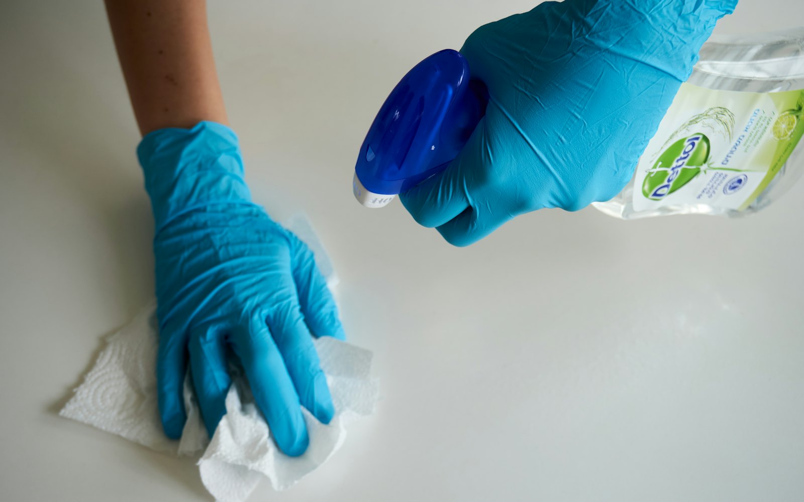 Gloved hand wiping a surface