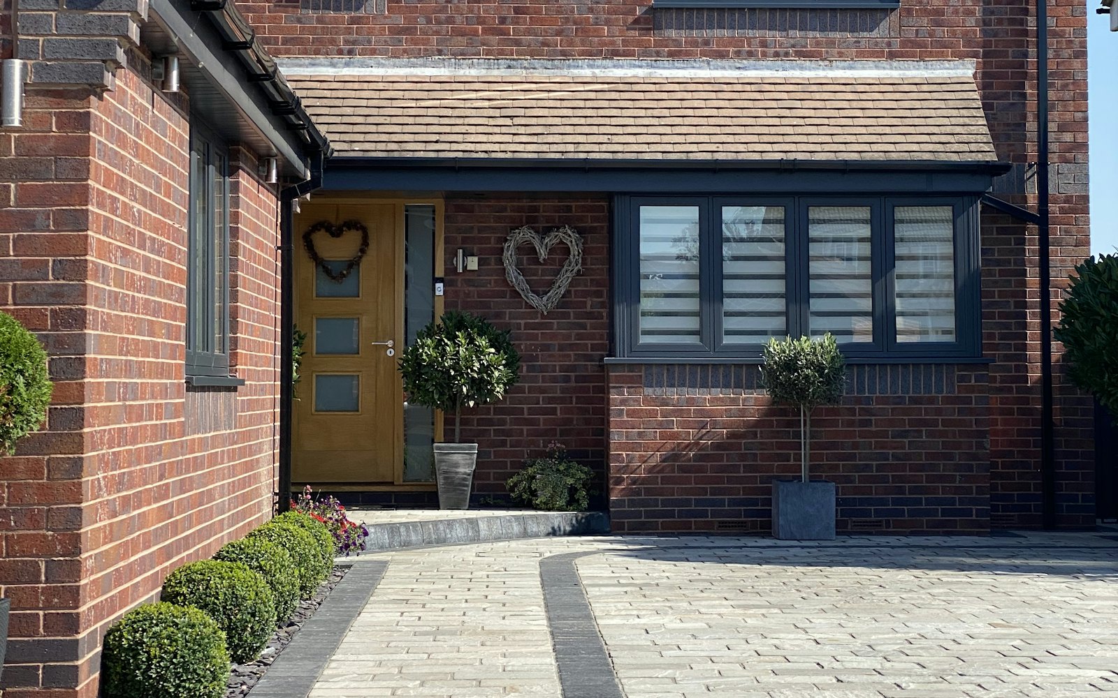 Brick house with a block-paved driveway