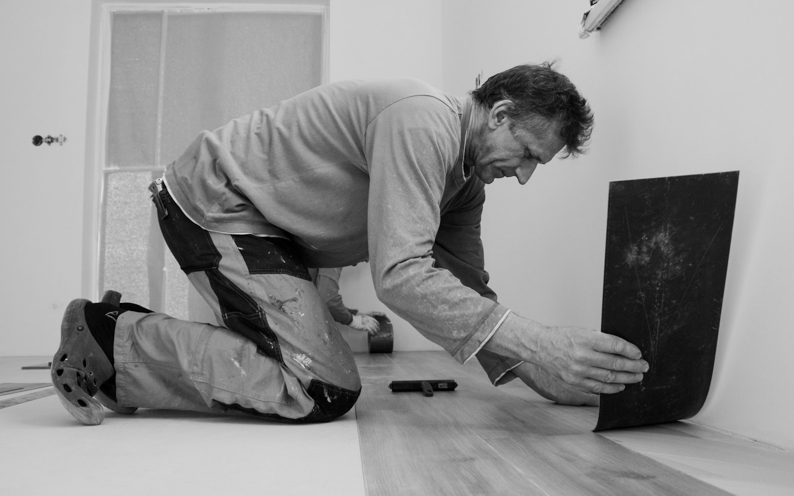 Fitter laying a new floor
