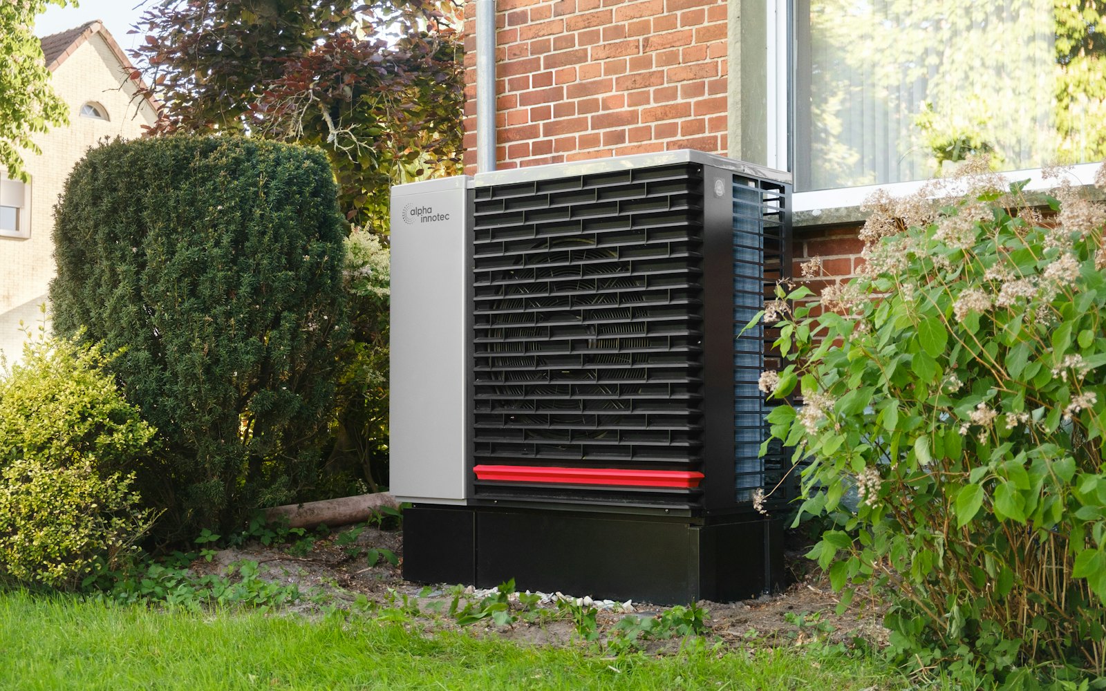 Outdoor heat pump unit next to a brick building