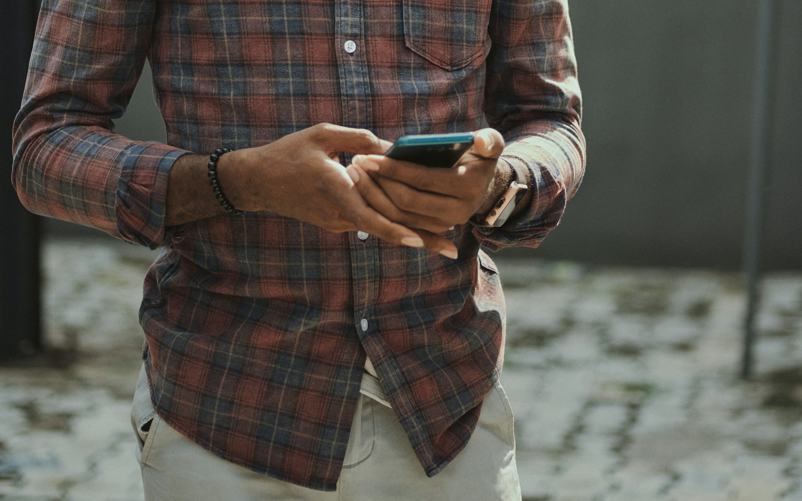 Builder in a hard hat checking his phone