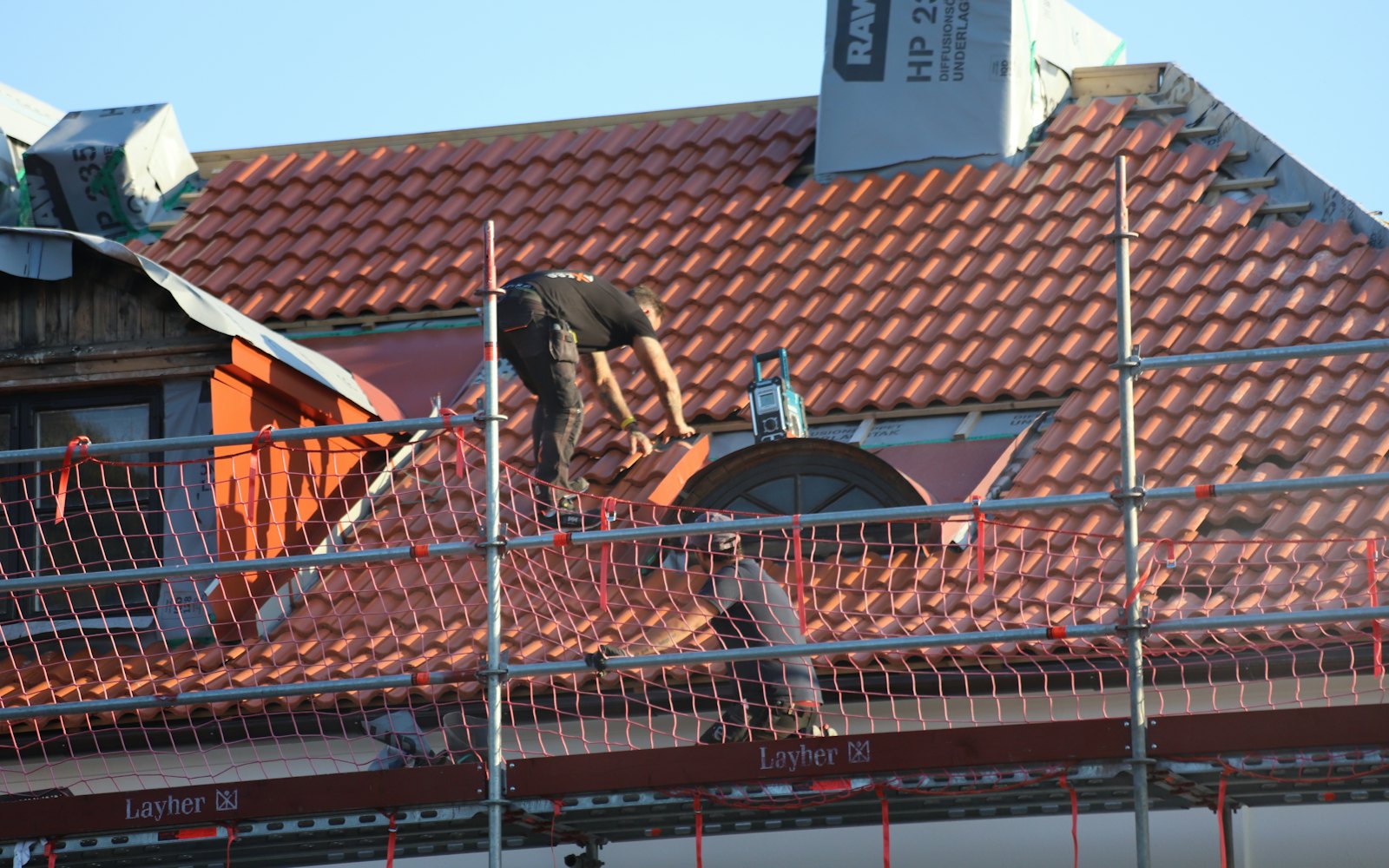 Roofer repairing a pitched roof