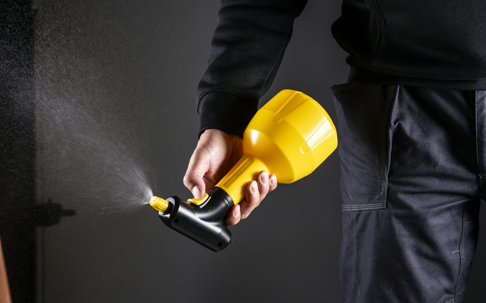 Pest control technician holding a spray unit