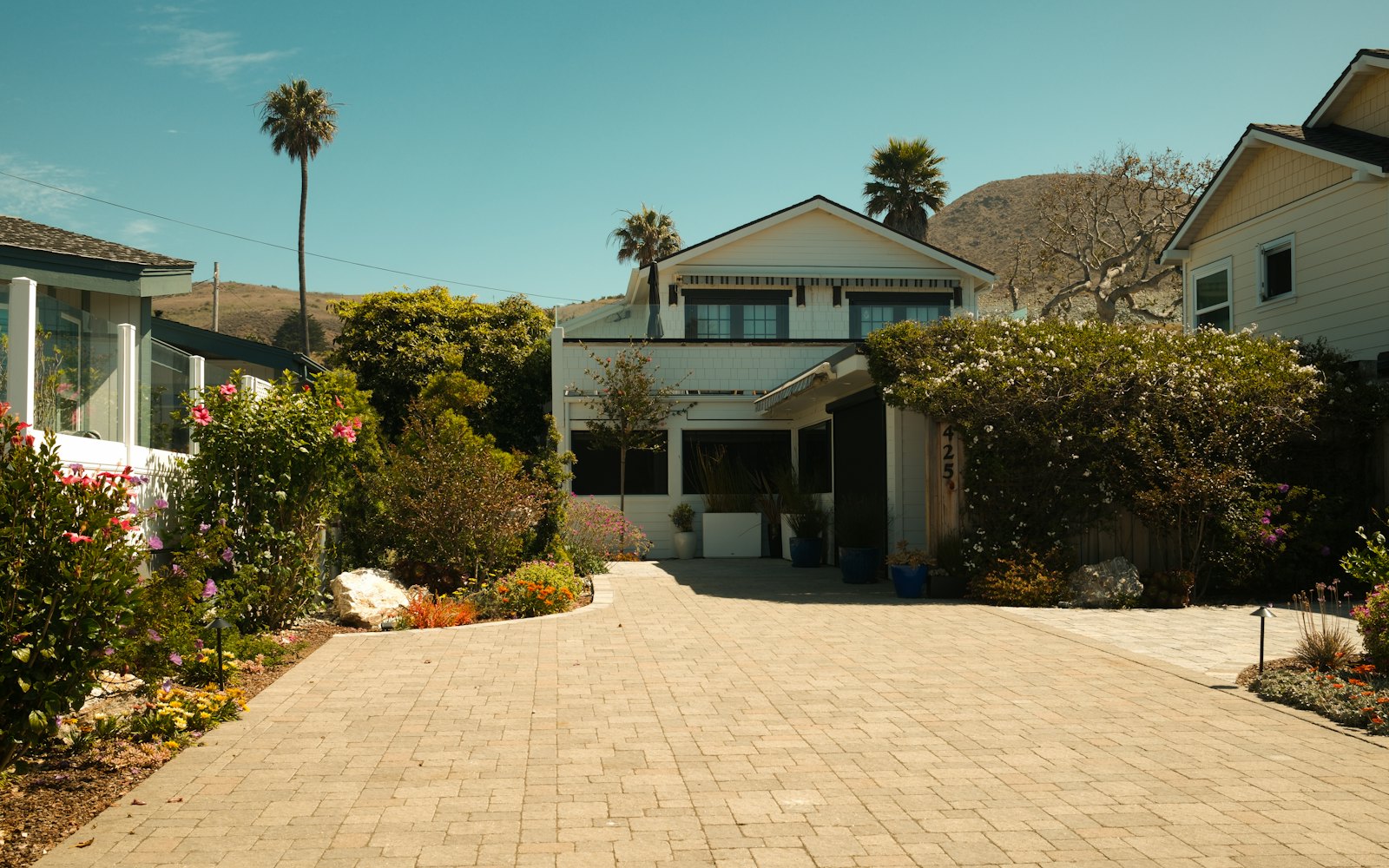 House with a long driveway and landscaped borders