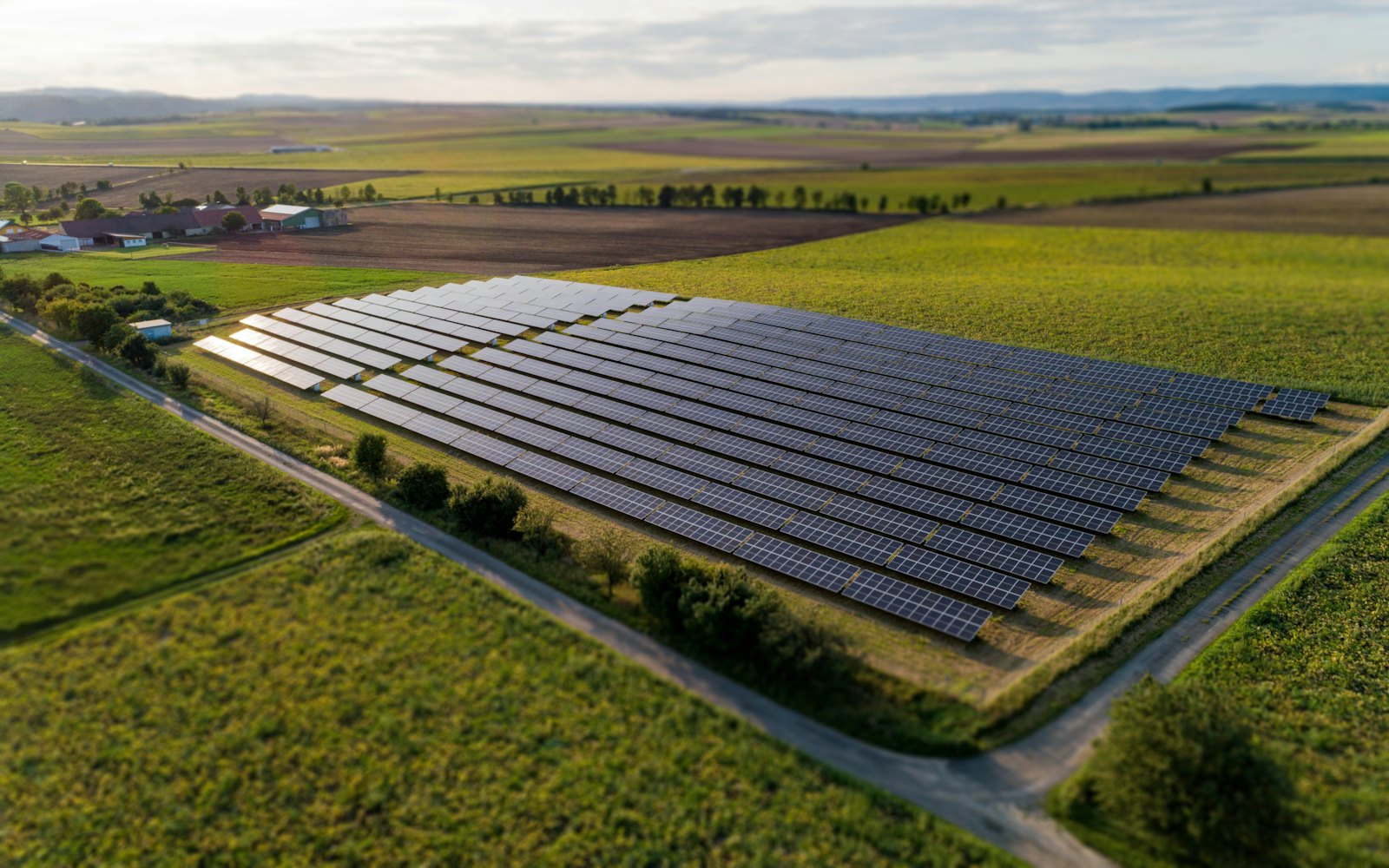 Ground-mounted solar panels in a green field
